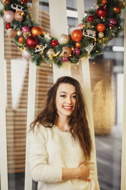 istock Girl standing in holiday background and looking at camera 642902390