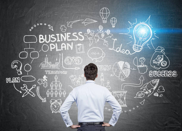 istock Rear view of man looking at business plan sketch 642917006
