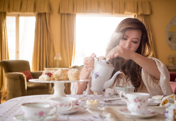 istock Asian woman preparing tea at home 642920166