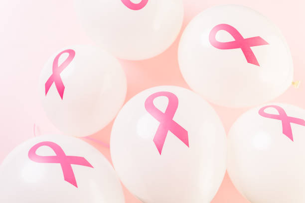 istock White latex balloons with pink ribbons 642923486