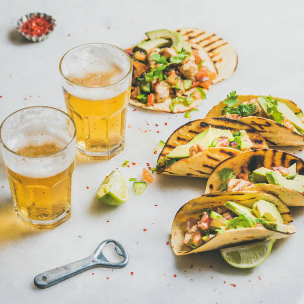 istock Healthy corn tortillas with beer in glasses over light background 642942774