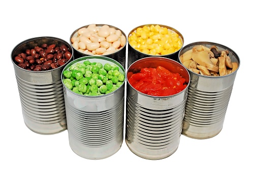 An isolated image of canned mushrooms, peas and corn