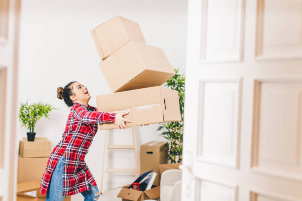 istock New beginings, woman unpacking at home 642949096