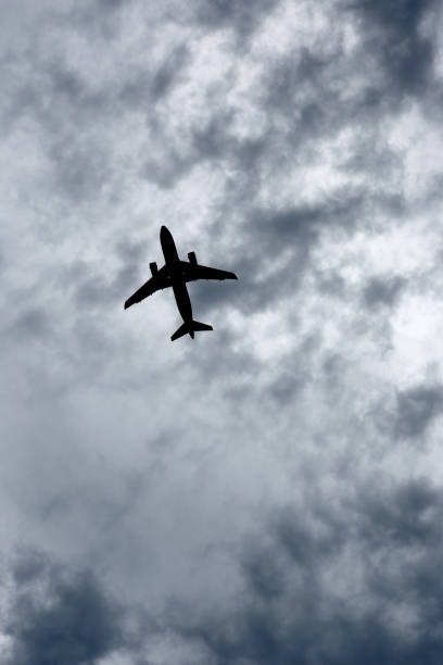istock Silhouetted airplane on stormy sky 642949344