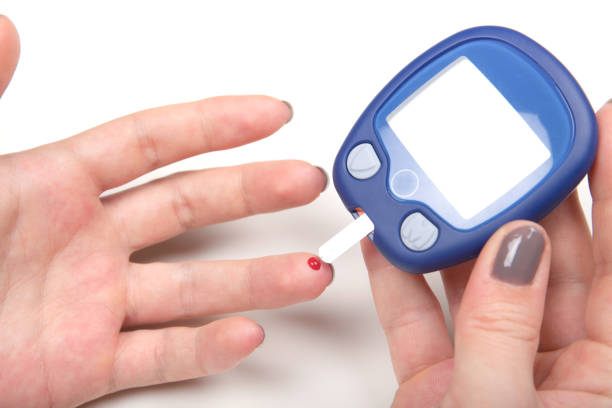 Close-up Of Woman Hands Testing High Blood Sugar With Glucometer stock photo