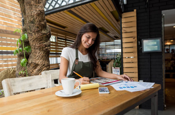 istock Business owner doing the books at a restaurant 642958566
