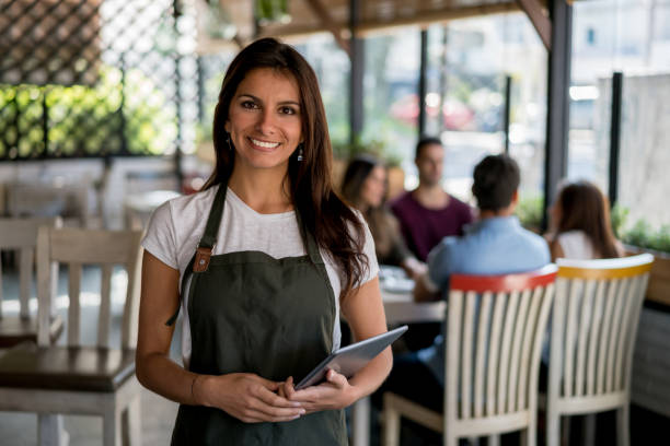 istock Happy business owner working at her restaurant 642958578