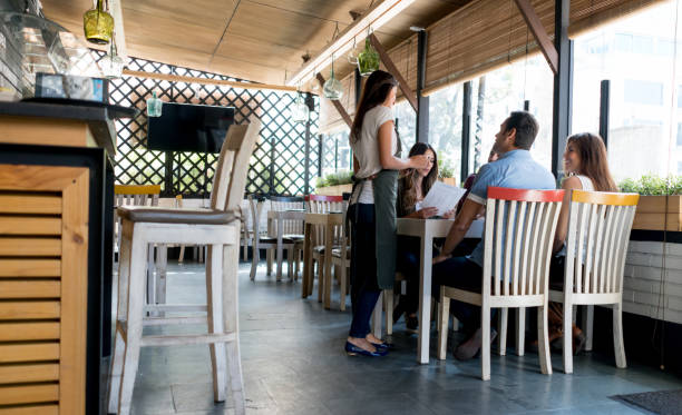 istock Waitress serving a group of friends at a restaurant 642958646