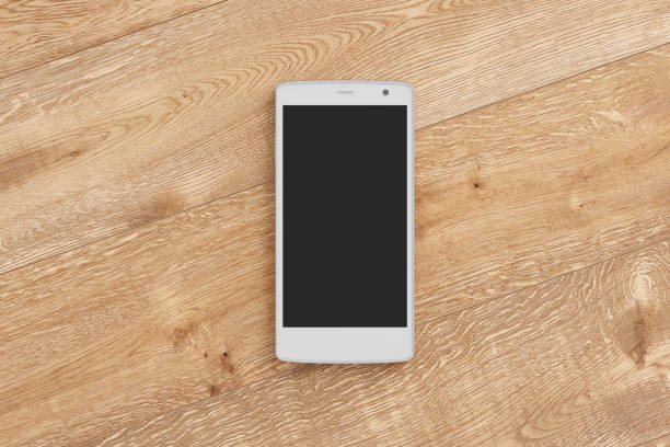 istock Smartphone on wooden background. 642961474