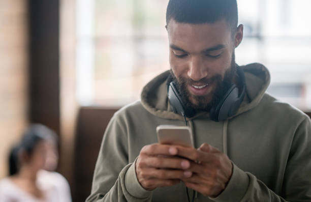 istock Young man on his cell phone at the office 642962074