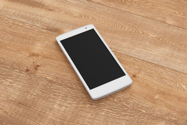 istock Smartphone on wooden background. 642962490