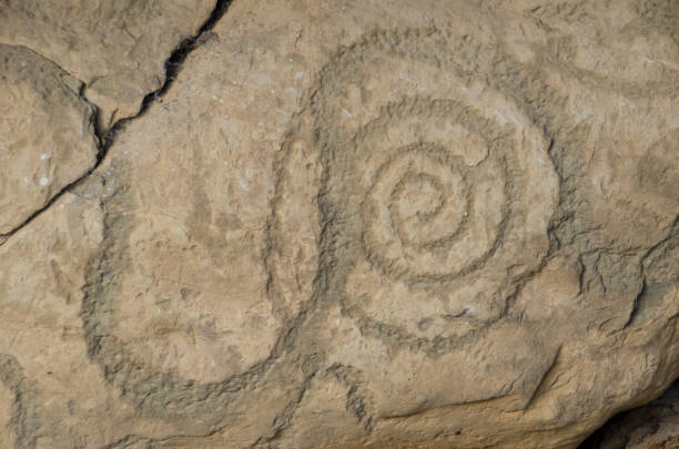 Petrogyph of a Spiral, from Knowth A rock engraving from the passag tomb of the megalithic structure of Knowth in Ireland. megalith stock pictures, royalty-free photos & images