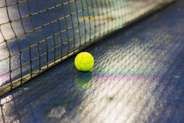 istock Tennis ball and net on wet ground after raining 642968598
