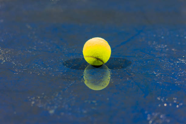 istock Tennis ball with reflection on ground after raining 642970228