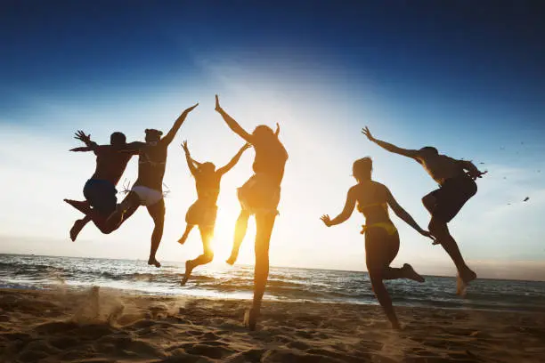 Photo of Happy friends sunset jump friendship holidays