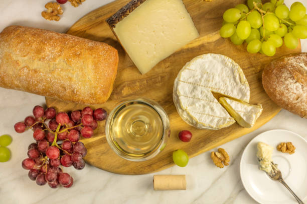istock White wine, cheese, bread and grapes at tasting 642983624