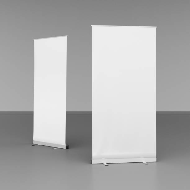 istock Blank roll up banner stands on gray floor 642986866