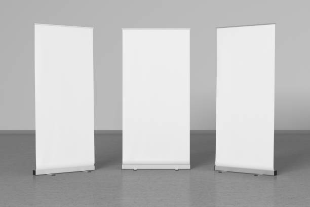 istock Blank roll up banner stands on gray floor 642986884