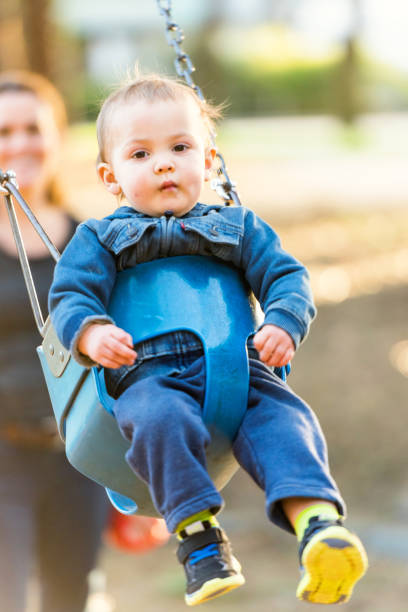 istock Mother and baby having fun in a park 642987150