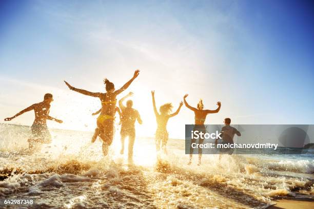 Crowd People Friends Sunset Beach Holidays Stock Photo - Download Image Now - Beach, Friendship, Summer