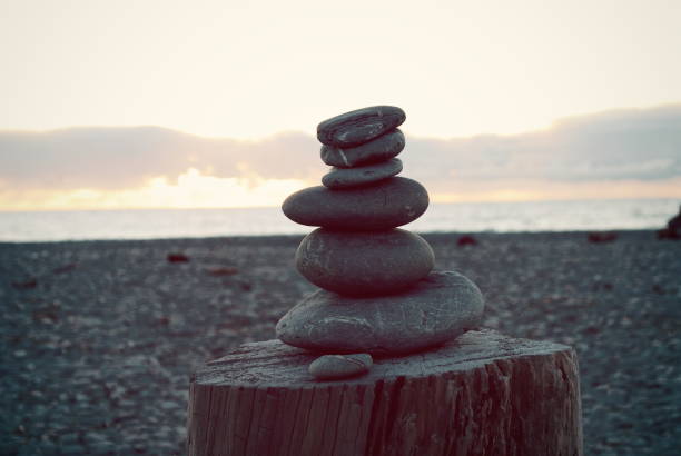 istock Stone Cairn Pile at Beach at Sunset 642994264