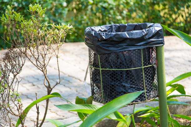 istock black plastic trash bag in metal container along a walkway 642994618