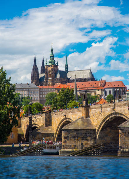 Prague castle and Wooden icebreaker that protects the pillars of Charles Bridge from the winter ice on the Vltava river in Prague stock photo