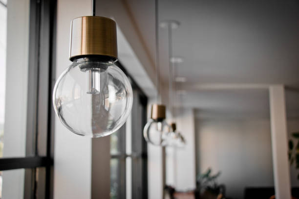 istock Hanging Light Bulb near glass window 642998438