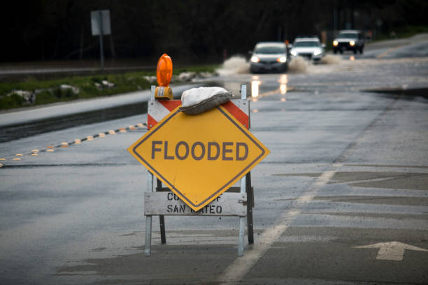 Flooded Road Flooded road in San Mateo County, California February 2017 flood stock pictures, royalty-free photos & images
