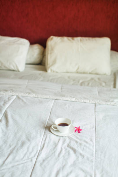 istock cup of tea and flower on white bed 643006154