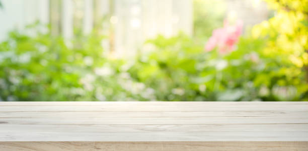 istock Wood table top on blur abstract green from garden background. 643009892