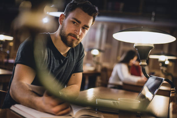 istock Portrait of a young man studying in the Library 643015056