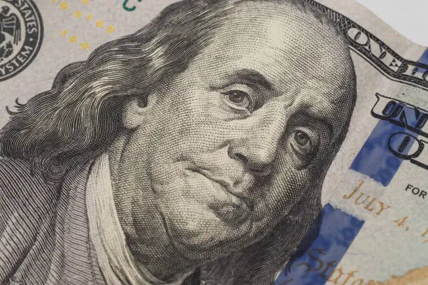 Photo of Dollars closeup. Benjamin Franklin's portrait on new one hundred dollar banknote.