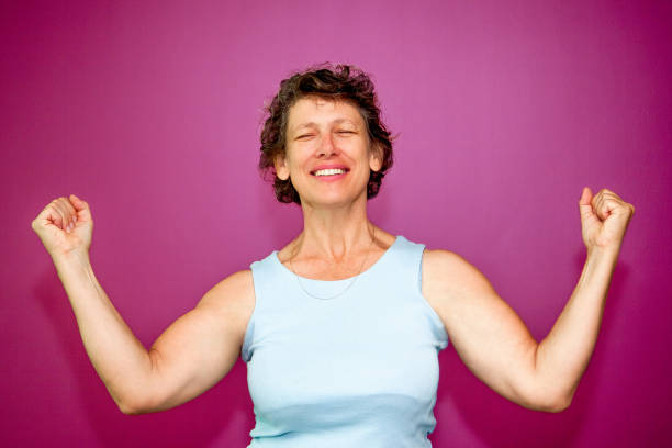 istock Happy senior woman enjoying success 643024486