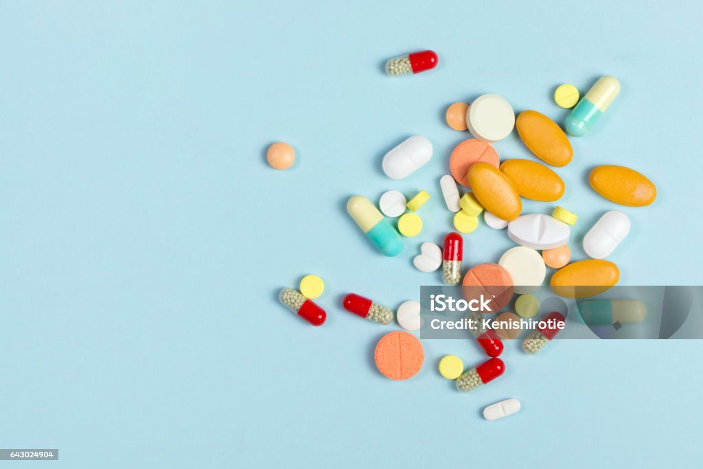 Drug or medicine Assorted pharmaceutical medicine pills, tablets and capsules over blue background Pill Stock Photo