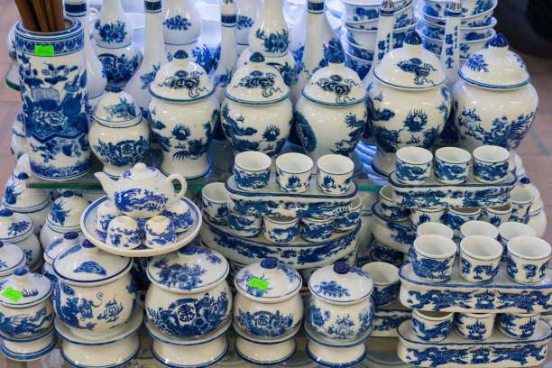 Hanoi, Vietnam - Jan 25, 2015: Pottery products on a shop in Bat Trang ancient ceramic village. Bat Trang village is the oldest and best known pottery village of Vietnam Hanoi, Vietnam - Jan 25, 2015: Pottery products on a shop in Bat Trang ancient ceramic village. Bat Trang village is the oldest and best known pottery village of Vietnam. bat trang stock pictures, royalty-free photos & images