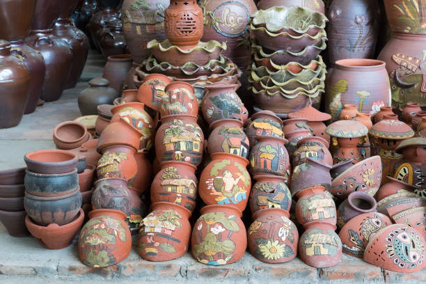 Hanoi, Vietnam - Jan 25, 2015: Pottery products on a shop in Bat Trang ancient ceramic village. Bat Trang village is the oldest and best known pottery village of Vietnam Hanoi, Vietnam - Jan 25, 2015: Pottery products on a shop in Bat Trang ancient ceramic village. Bat Trang village is the oldest and best known pottery village of Vietnam. bat trang stock pictures, royalty-free photos & images