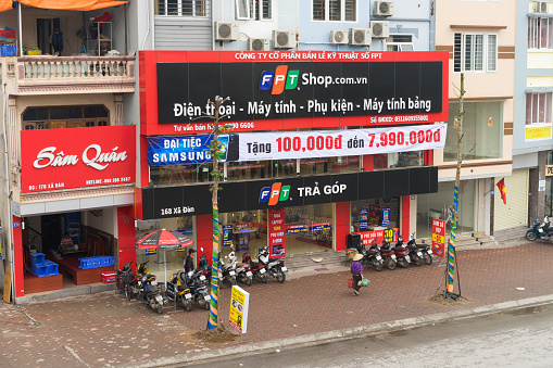 Hanoi, Vietnam - Mar 15, 2015: Front view of a high technology store of FPT Telecom in Xa Dan street in Hanoi capital. FPT is one of the biggest technology groups in Vietnam.