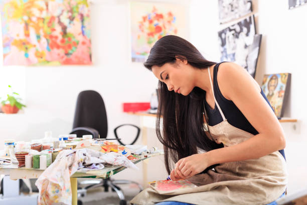 istock Female artist working in studio 643035238