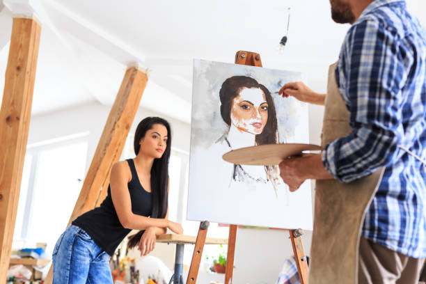 artist making portrait of young woman - women artist painting easel imagens e fotografias de stock