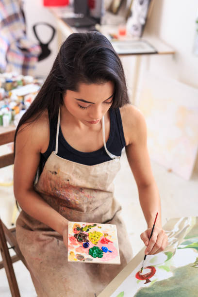 istock High angle view of female painter 643035248