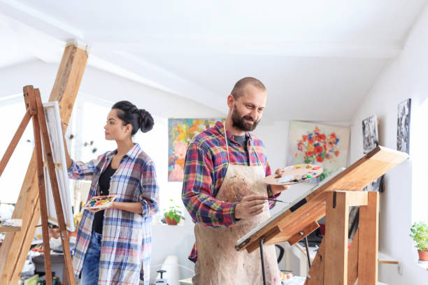 istock Teacher and student drawing together in modern atelier 643035338