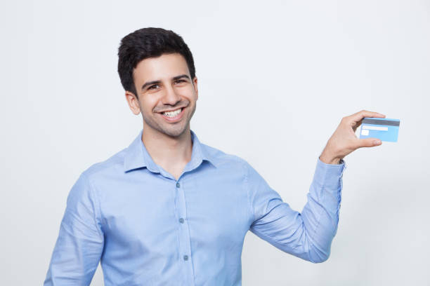 istock Happy Young Handsome Man Showing Bank Card 643038942