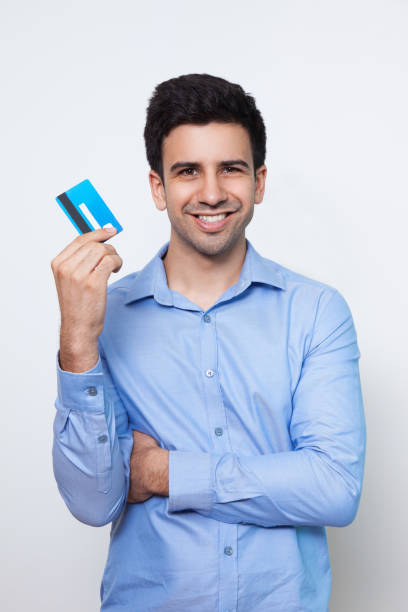 istock Smiling Young Attractive Man Holding Credit Card 643039038