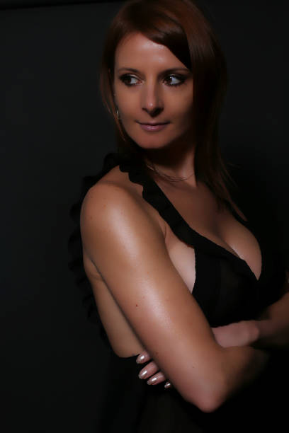 istock Sexy redhead wearing a black nightie 643043024