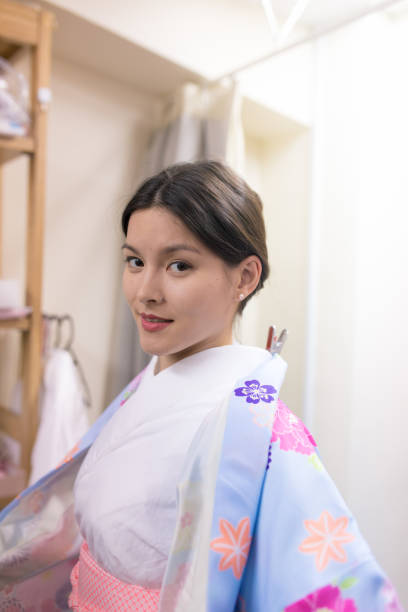 istock Young woman wearing Kimono in fitting room 643043040