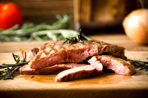 istock rare steak rosemary rectangular wooden cutting board pepper 643043204