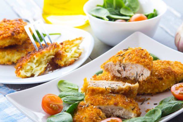 istock Food fried breading chicken spinach salad tomatoes pancakes from potatoes 643046236