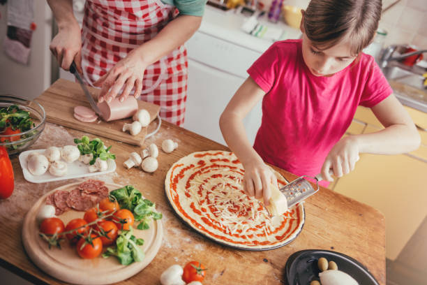 istock Mother and daughter preparing pizza 643046470