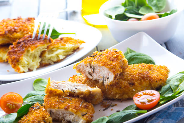 istock Food fried breading chicken spinach salad tomatoes pancakes from potatoes 643046632